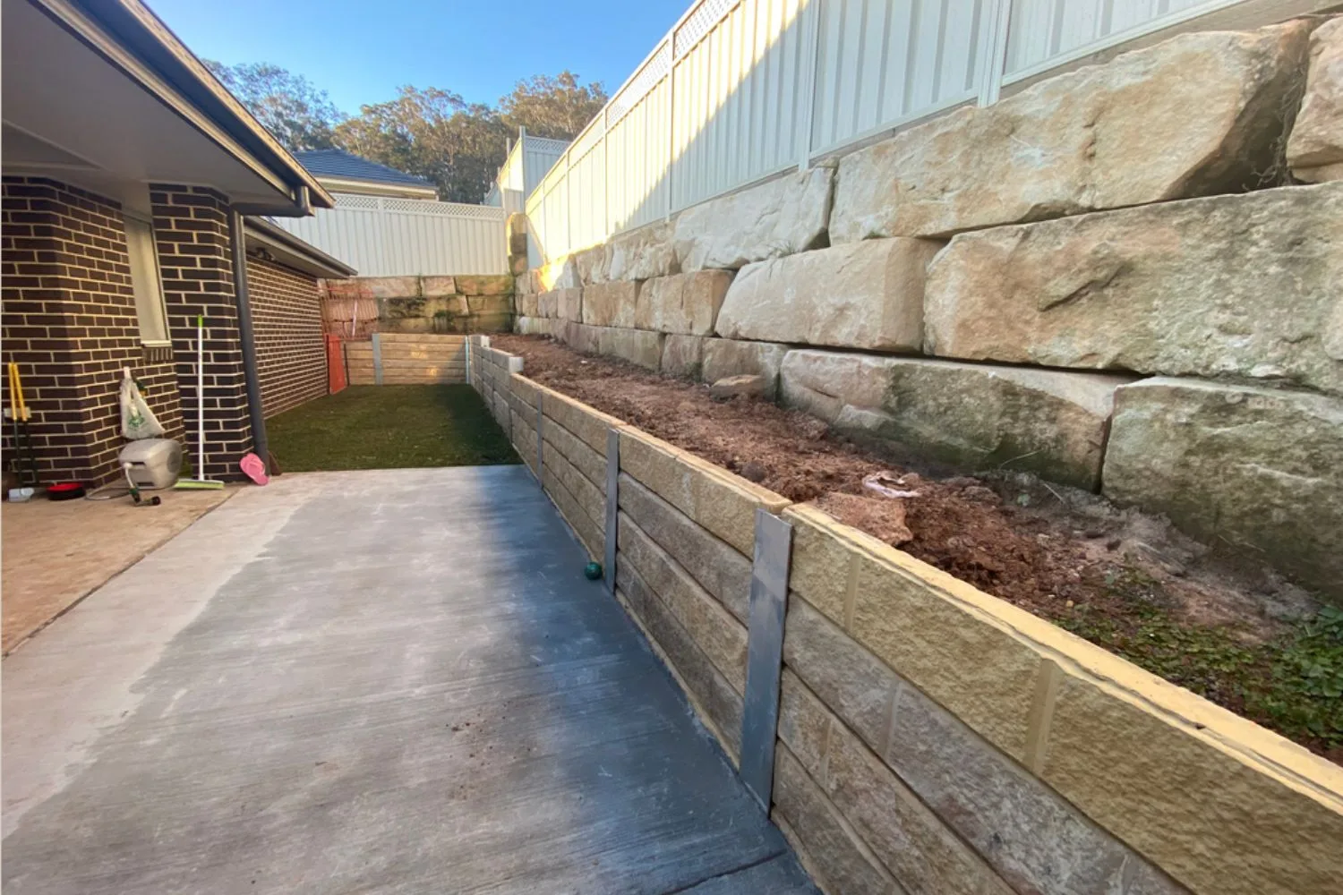 Concrete sleeper retaining wall finished on a Pymble ridge block
