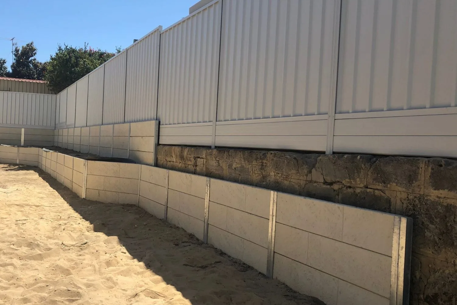 Steel-reinforced concrete sleeper retaining wall