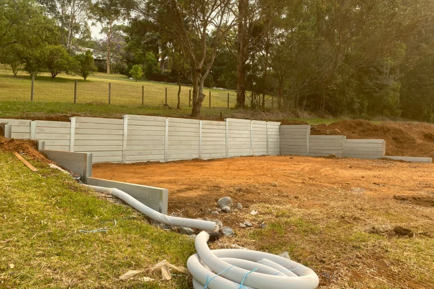 Concrete sleeper retaining wall along a driveway