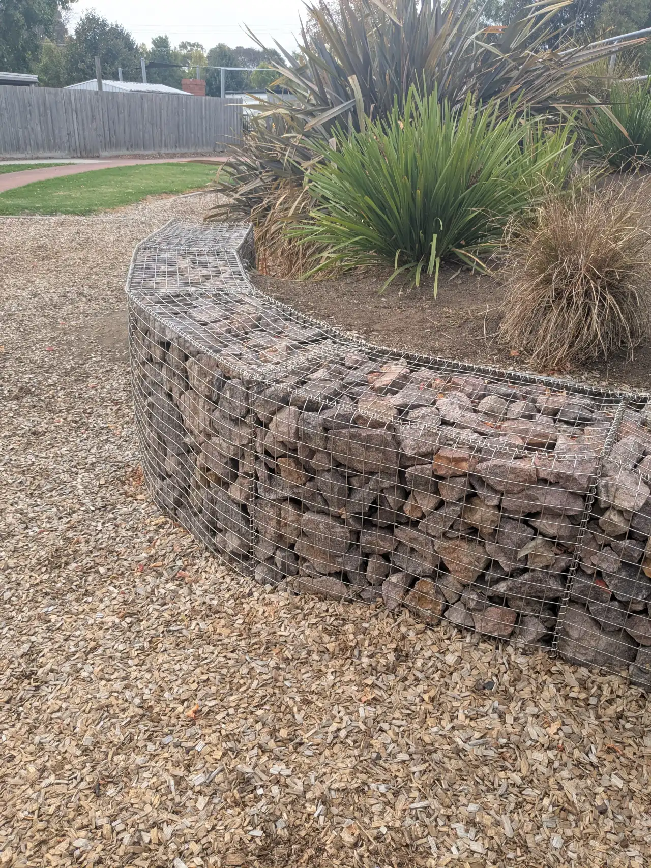 Gabion wire cage retaining wall on a sloped site