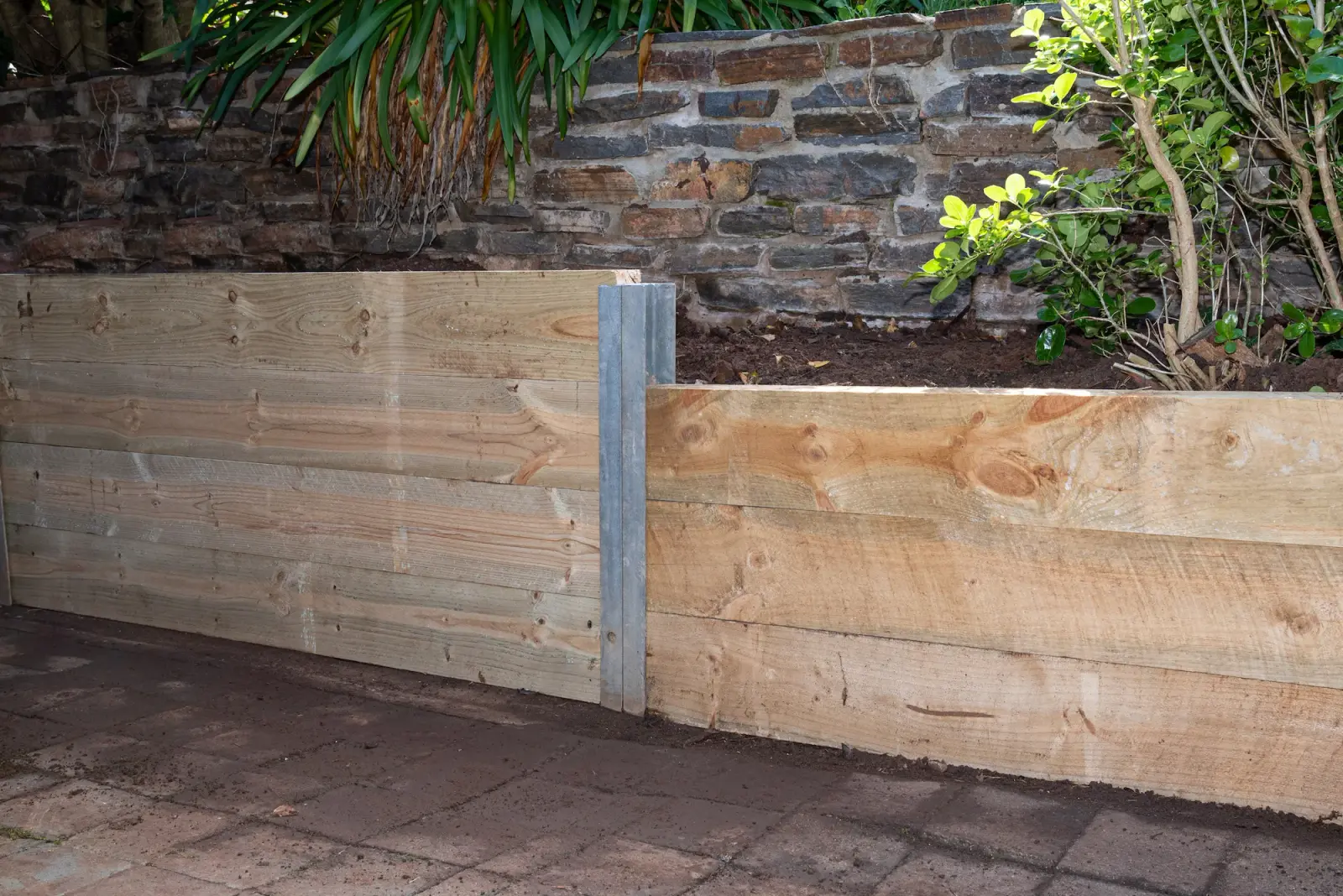 Timber retaining wall built around mature trees in Killara
