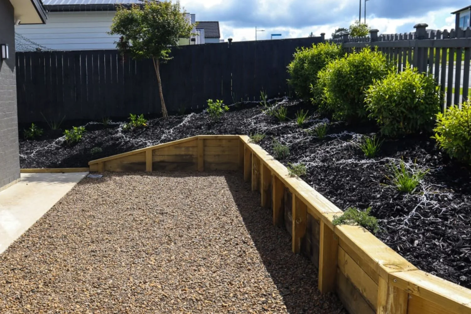 Treated timber retaining wall on a landscaped block