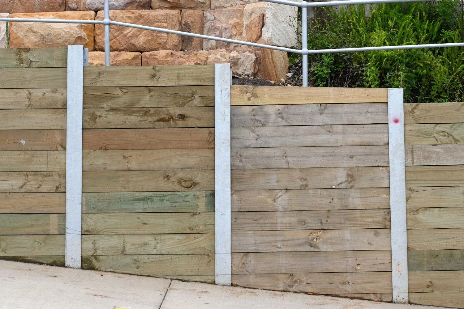 Timber retaining wall bordering a garden bed